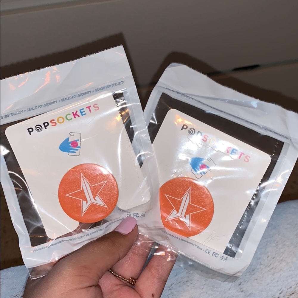 Orange Jeffree Star Popsockets💜